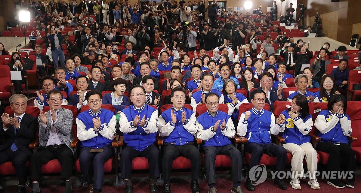 Members of the main opposition Democratic Party erupt in joy as they watch the exit polls at the National Assembly in Yeouido in western Seoul, on April 10, 2024. (Pool photo) (Yonhap)