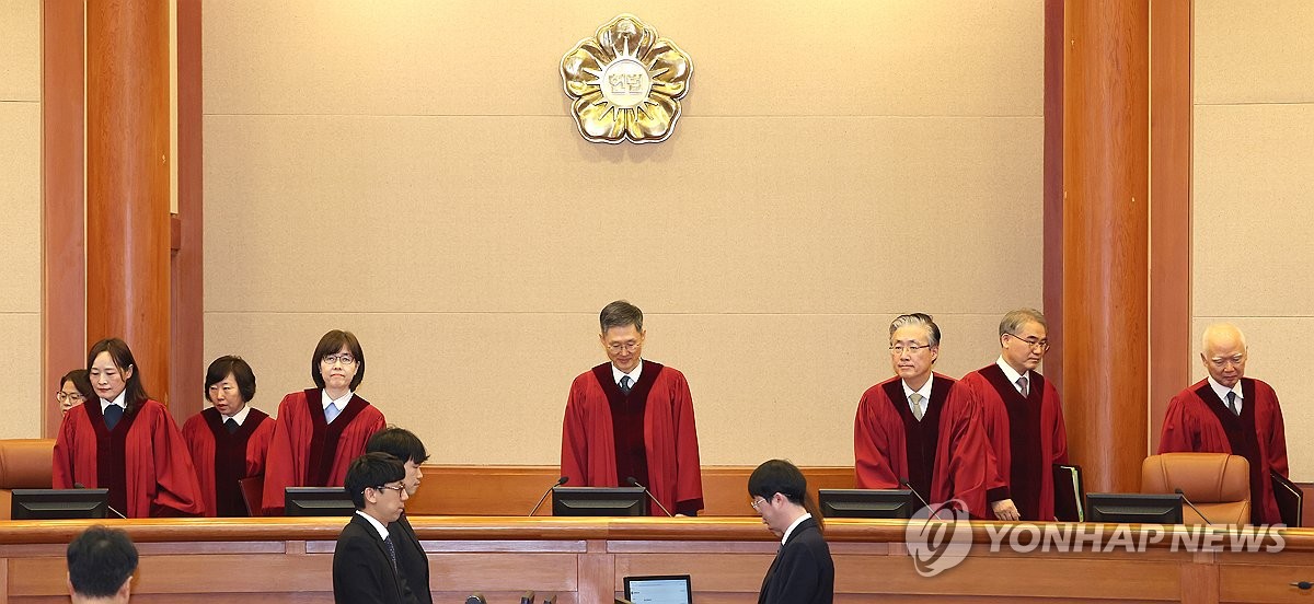 The Constitutional Court justices sit in their courtroom in Seoul on Jan. 14, 2025, to attend the first formal hearing of President Yoon Suk Yeol's impeachment trial over his short-lived imposition of martial law, with Yoon absent from the proceedings out of safety concerns. (Yonhap)